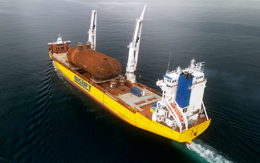 Aerial view of a special Biglift ship with a huge tank as cargo