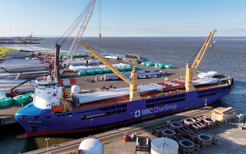 A crane loads rotor blades onto a BBC Chartering ship