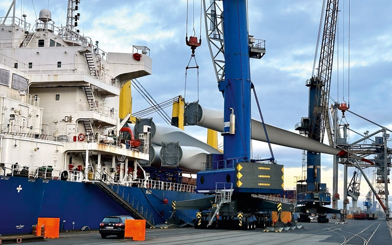 Bird's eye view of a crane loading goods onto a ship at the quayside